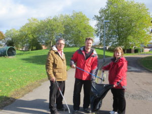 Councillors Derique Montaut, Chris Watts, and Fay Howard clearing litter