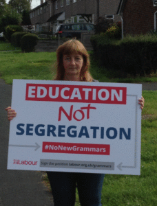 Councillor Fay Howard with sign reading "Education not Segregation"