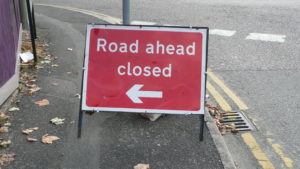 Sign reading "Road ahead closed"